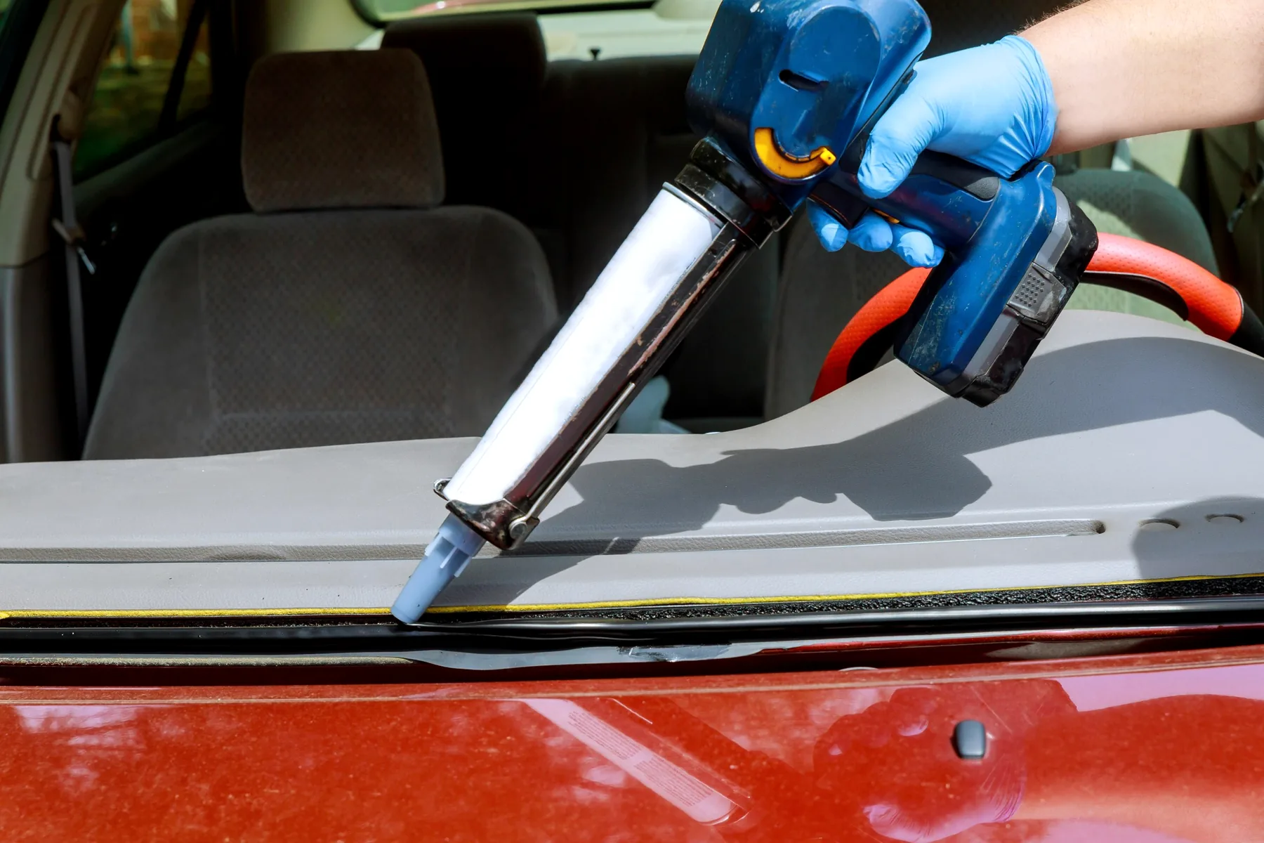 Auto glass replacement detail during windshield service